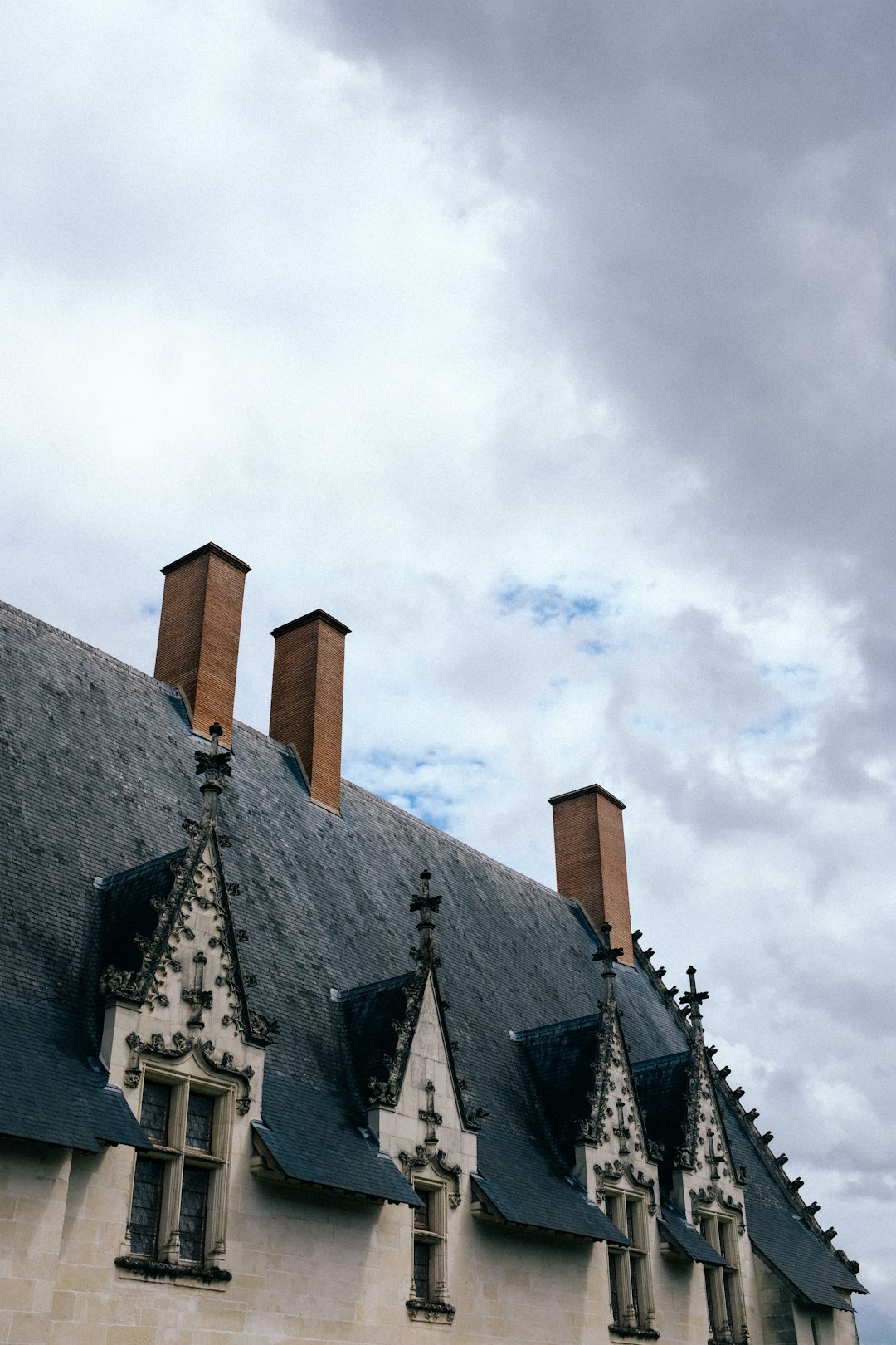 brown and black concrete building under white clouds during daytime