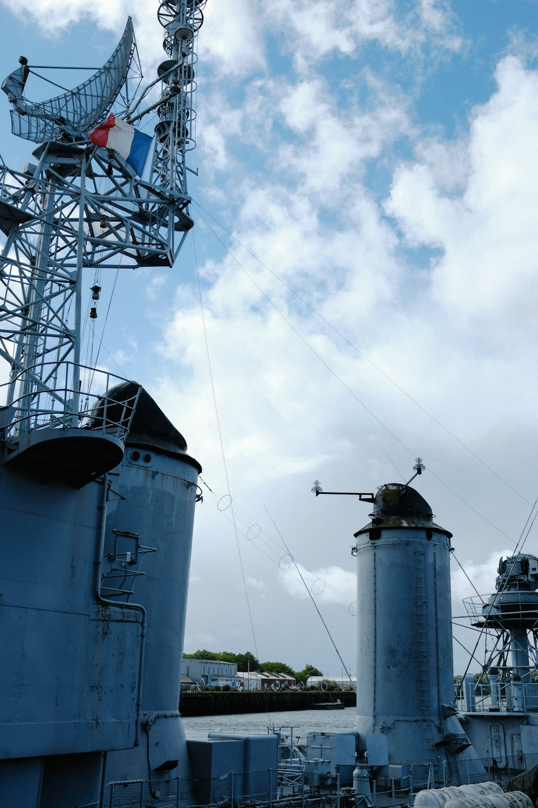 white and gray metal tower under white clouds during daytime