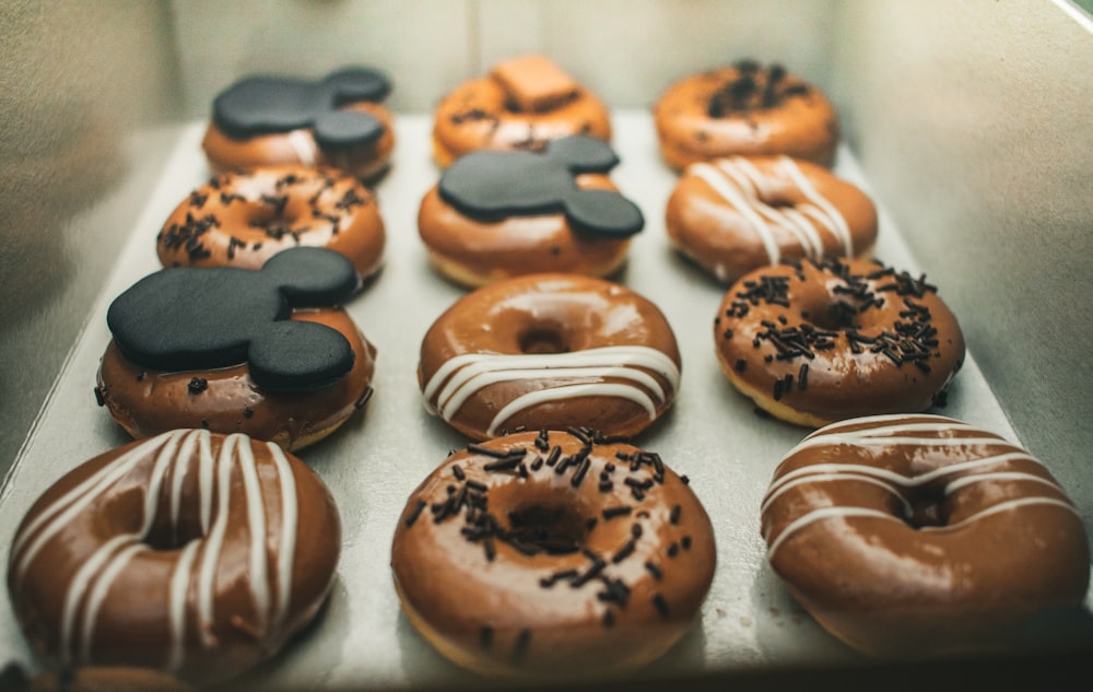 brown and white doughnuts on white paper