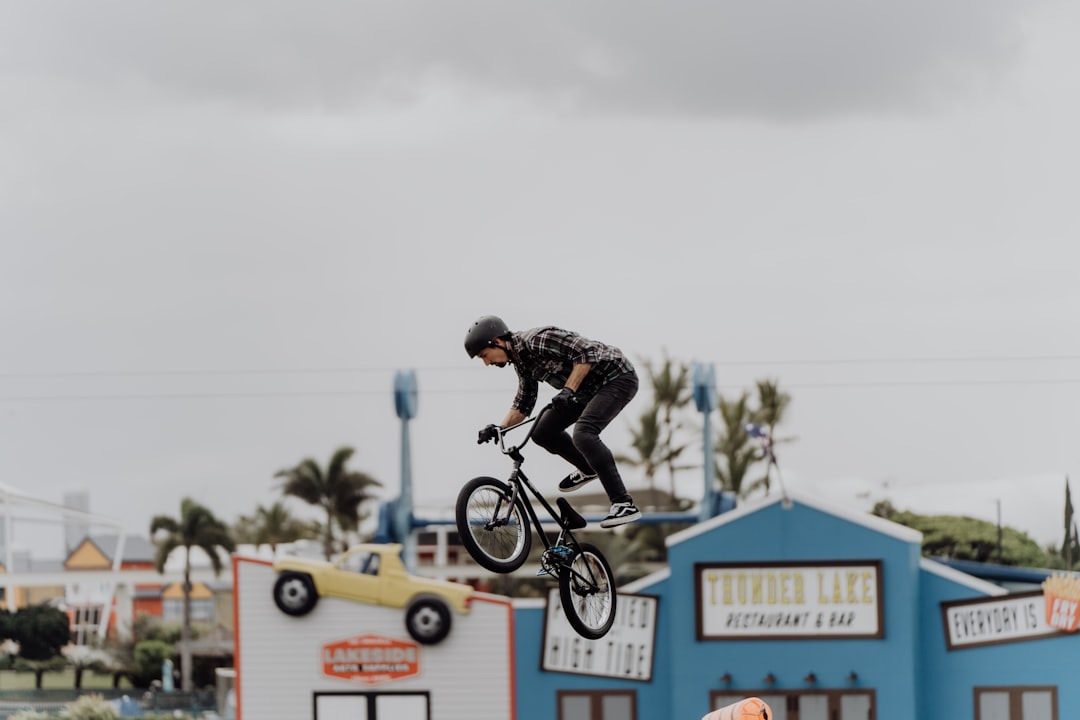 man in black jacket riding bicycle during daytime