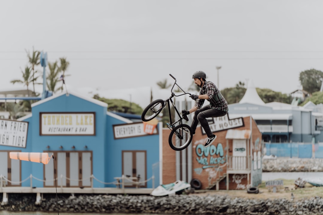 man in black jacket riding bicycle during daytime