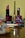 A neatly arranged collection of cosmetics with a prominent rose-colored lipstick in the foreground. Various makeup items, including a nail polish and lip liners, are set against a blurred background.