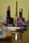 A neatly arranged collection of cosmetics with a prominent rose-colored lipstick in the foreground. Various makeup items, including a nail polish and lip liners, are set against a blurred background.