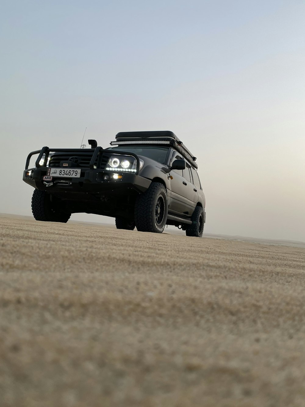 black jeep wrangler on brown field during daytime