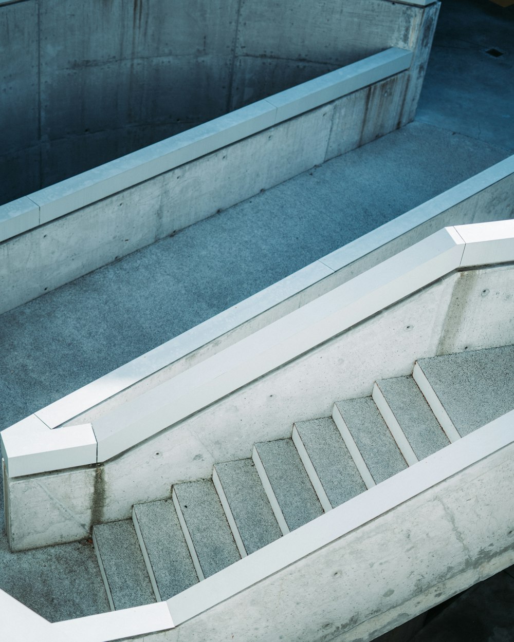 white concrete staircase with gray metal railings