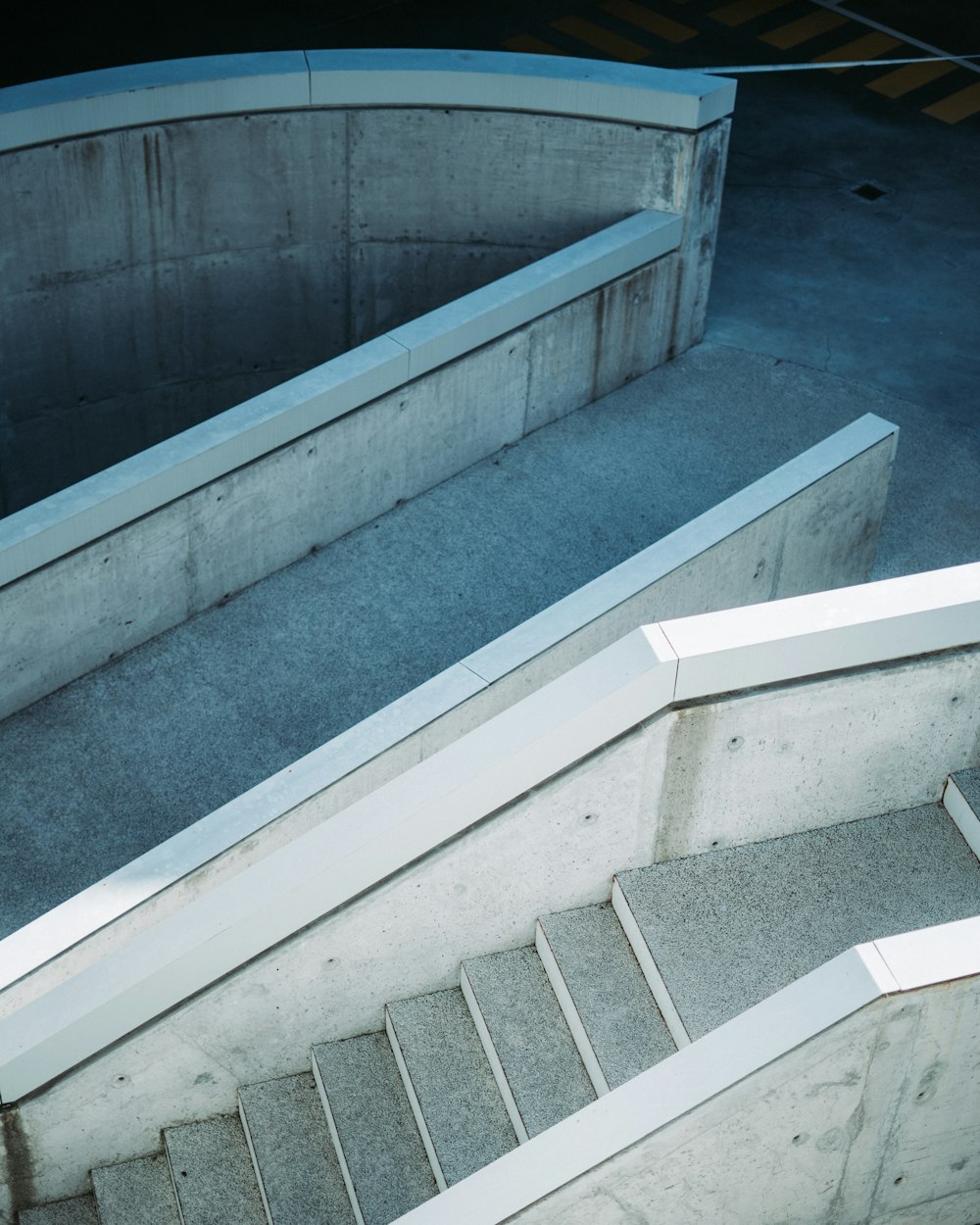 gray concrete stairs with blue metal railings