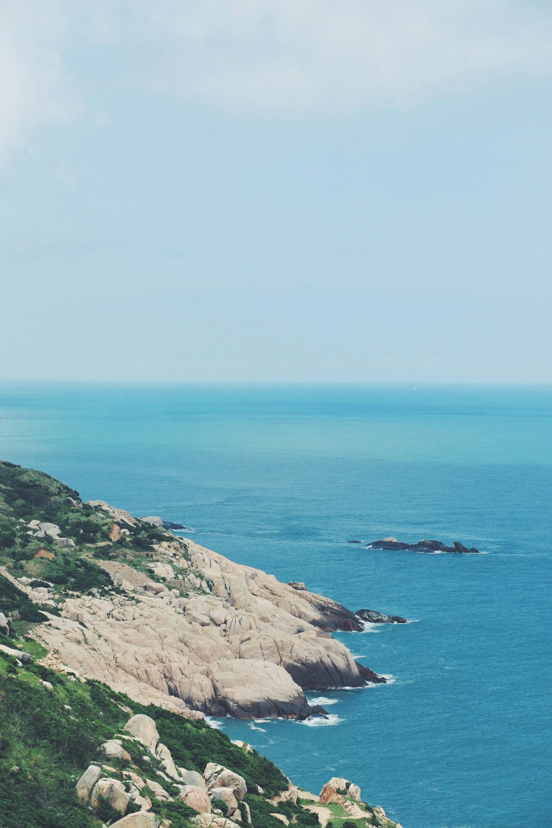 body of water near mountain during daytime