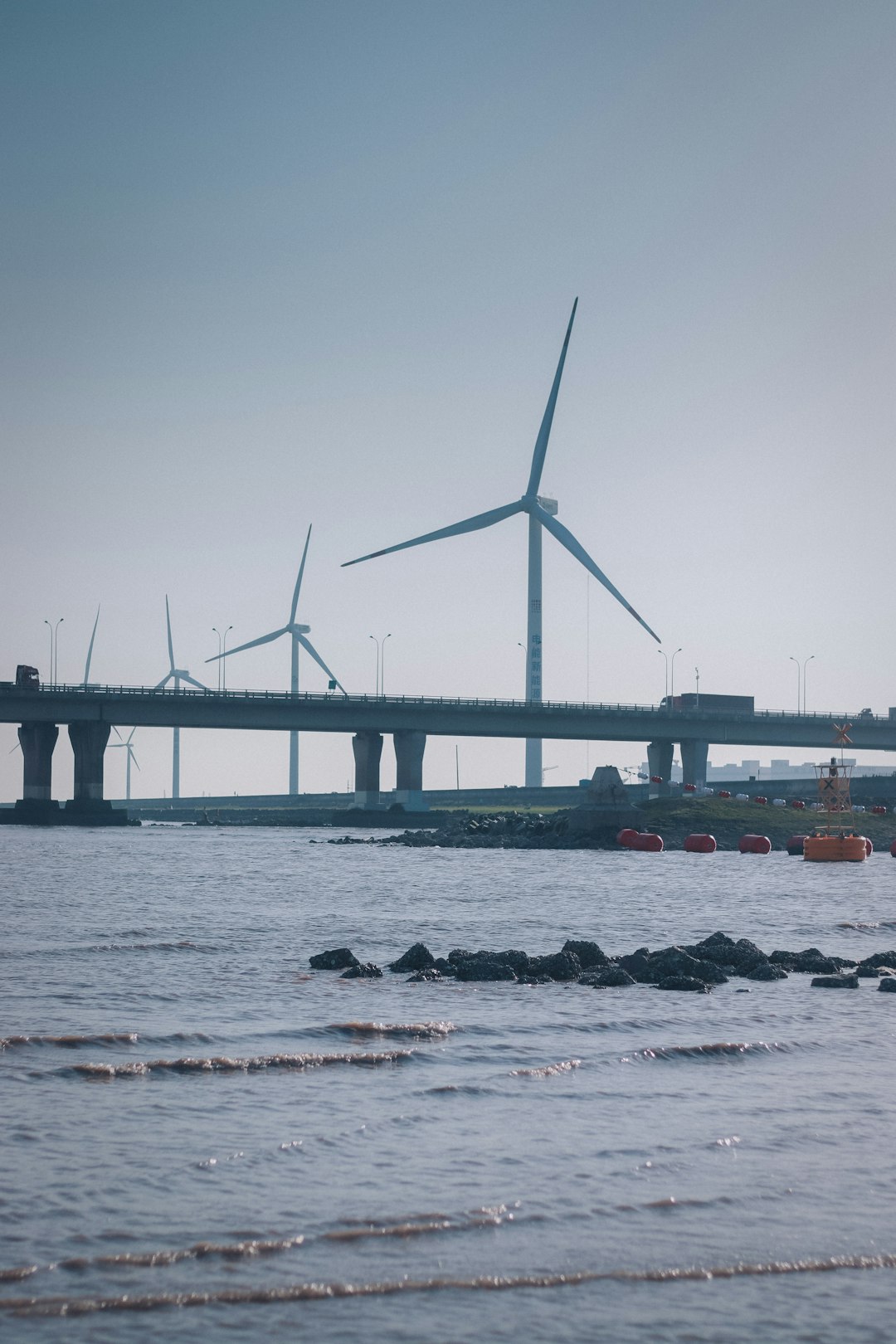 wind turbines on shore during daytime