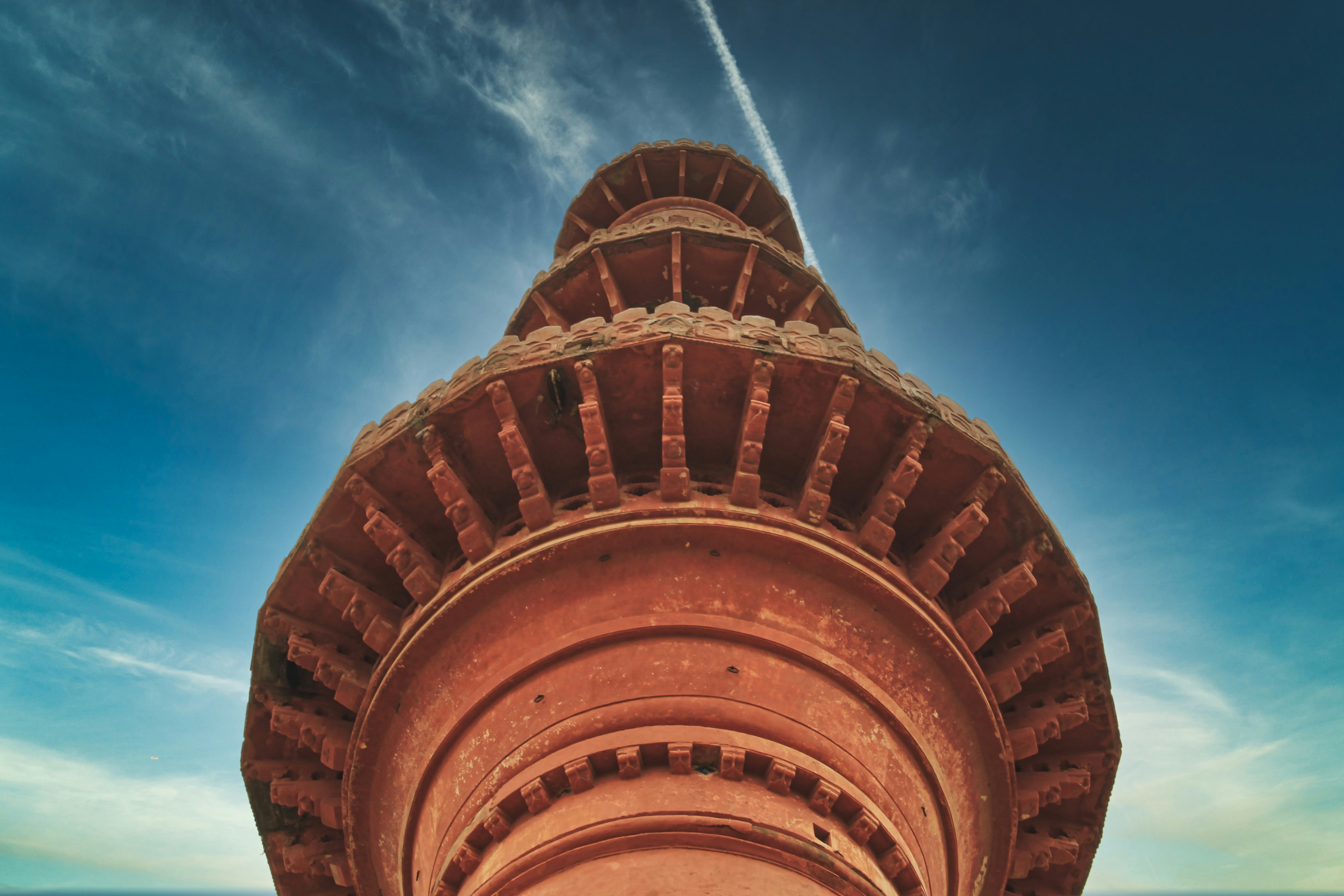 brown concrete building under blue sky during daytime, Bottom view of the brackets of Chand Minar, Daulatabad.