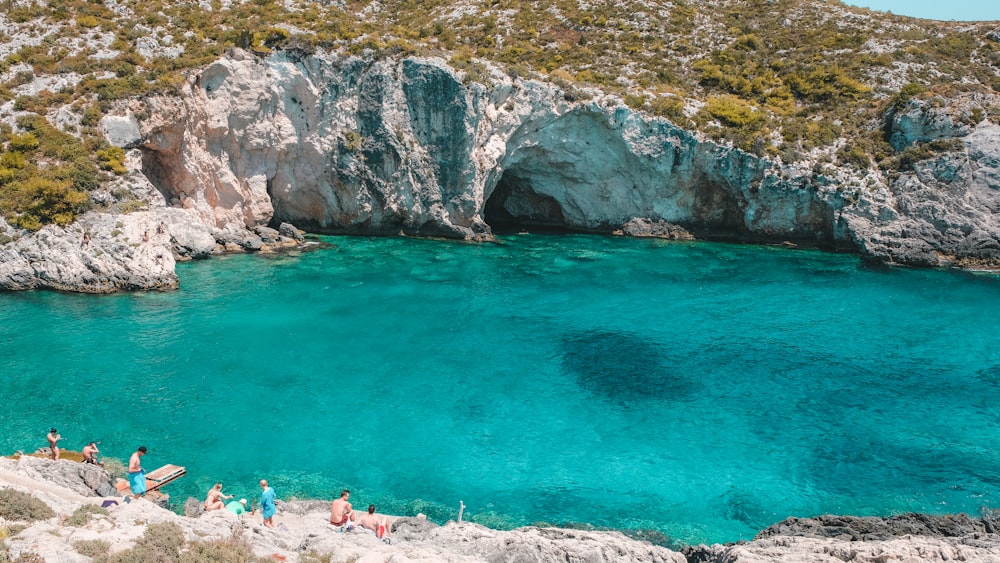 people swimming on beach during daytime