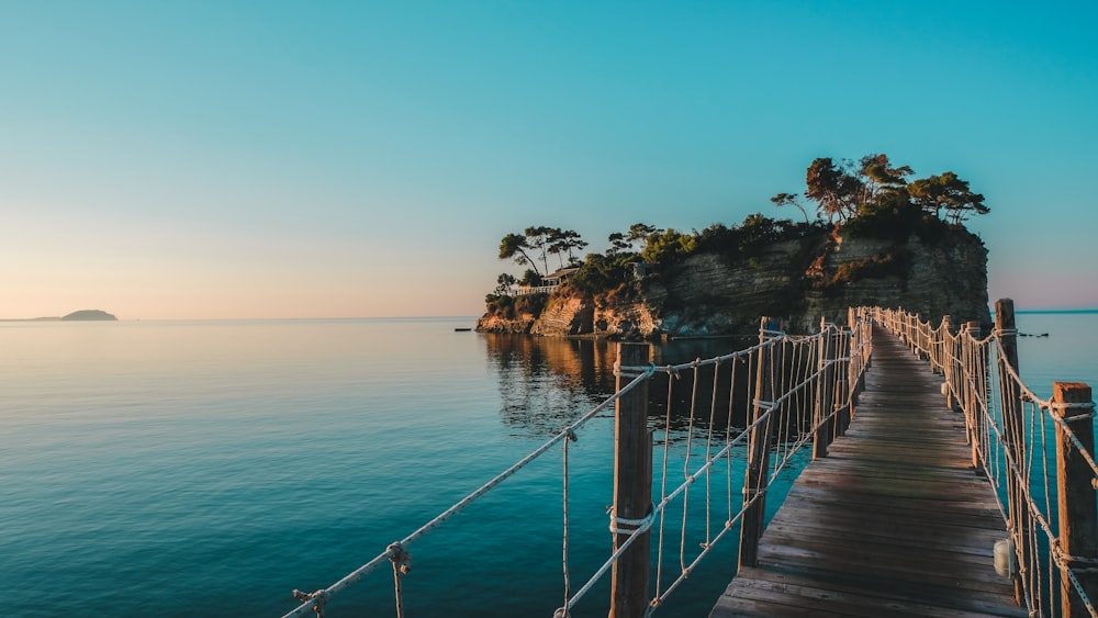 brown wooden dock on blue sea under blue sky during daytime