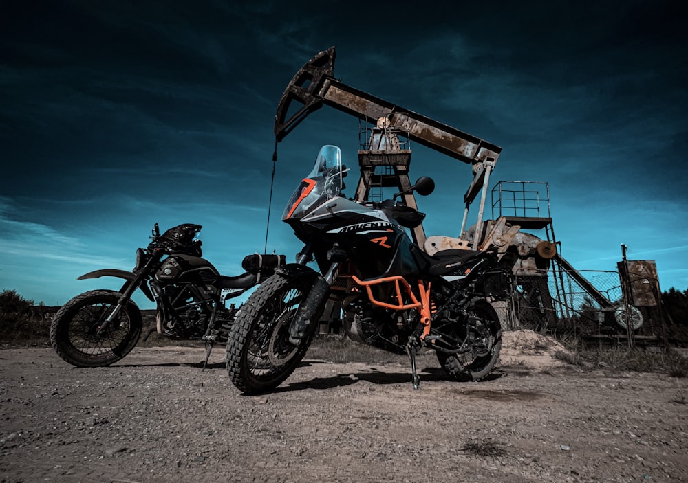 black and orange motorcycle near brown wooden building