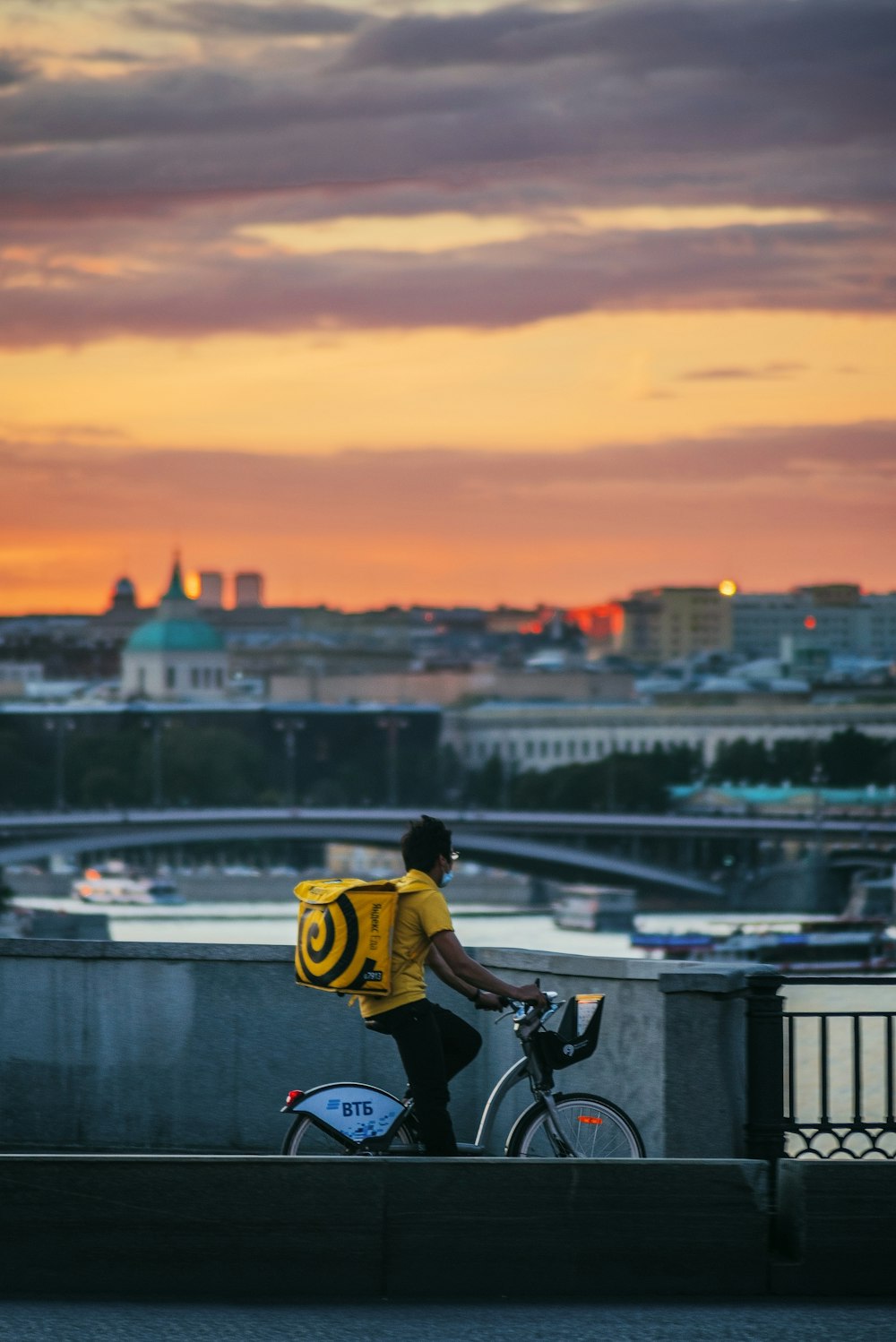 man in yellow shirt riding bicycle during daytime