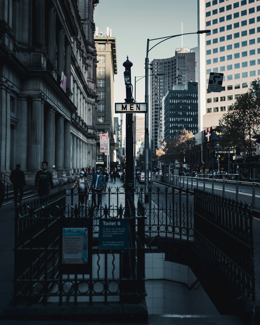 people walking on sidewalk near buildings during daytime