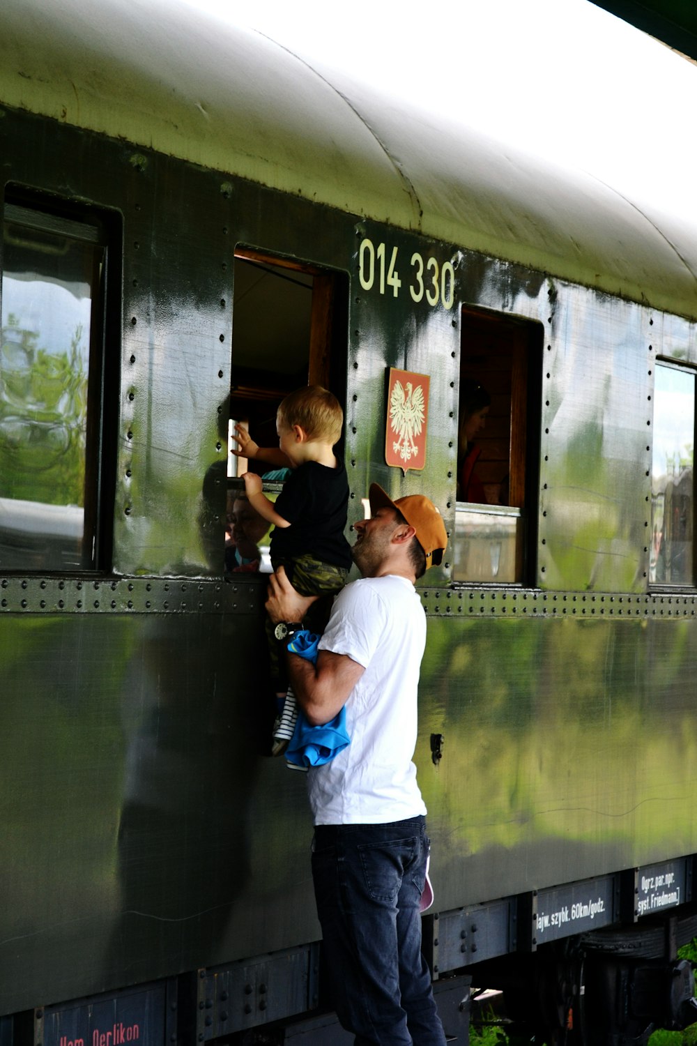 man in white shirt holding black dslr camera