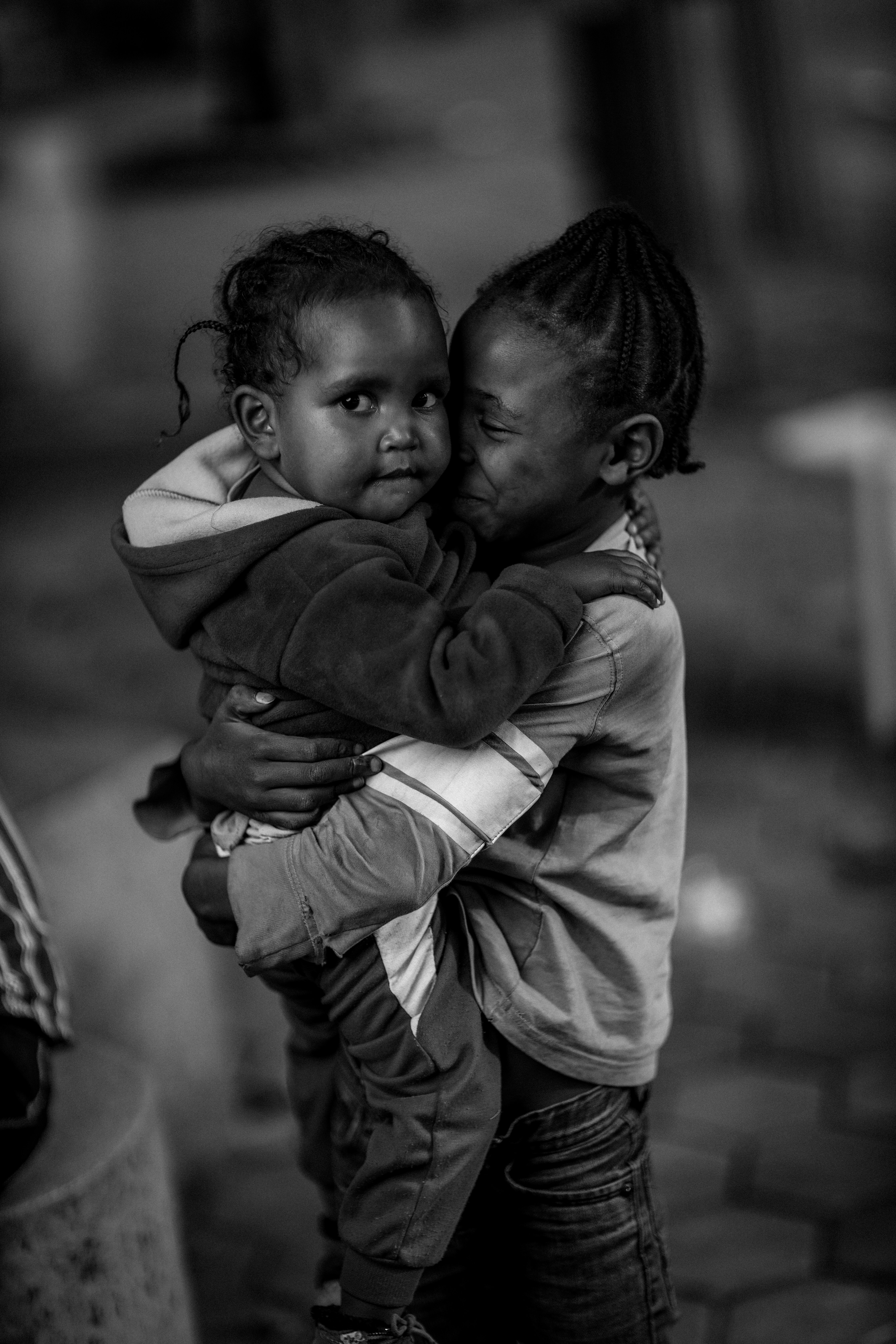 grayscale photo of child in hoodie