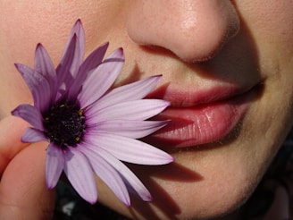 woman with pink and white flower on her face