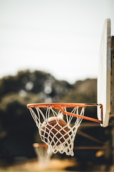 Close-up of a basketball swishing through a net during an intense game