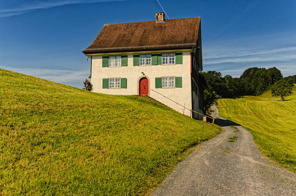 red and white concrete building near green grass field during daytime