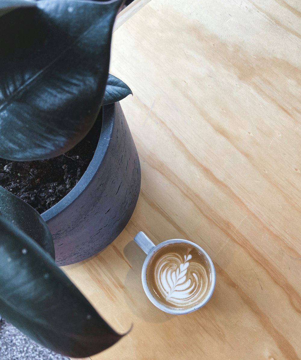 white ceramic cup on brown wooden table