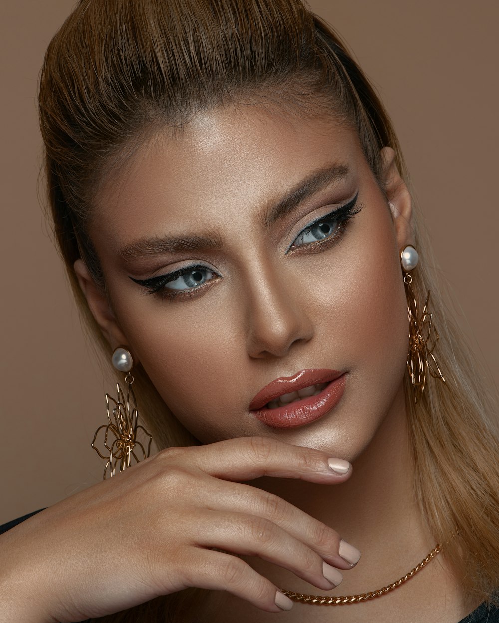 woman with silver earrings and silver necklace