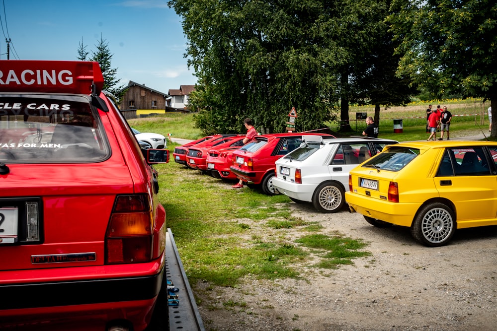 red and yellow cars on parking lot during daytime