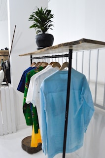 blue textile on brown wooden rack