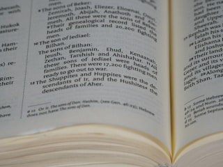 An open book displaying text in black font on cream-colored pages. The text includes headings and paragraphs in a serif typeface, and there are visible margins and page edges.