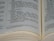 An open book displaying text in black font on cream-colored pages. The text includes headings and paragraphs in a serif typeface, and there are visible margins and page edges.