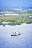 white boat on body of water during daytime