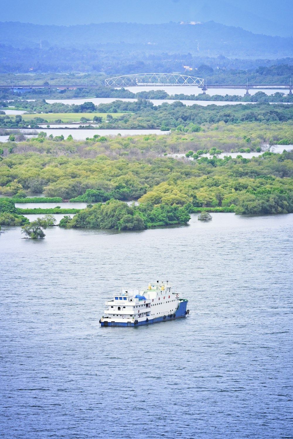 white boat on body of water during daytime