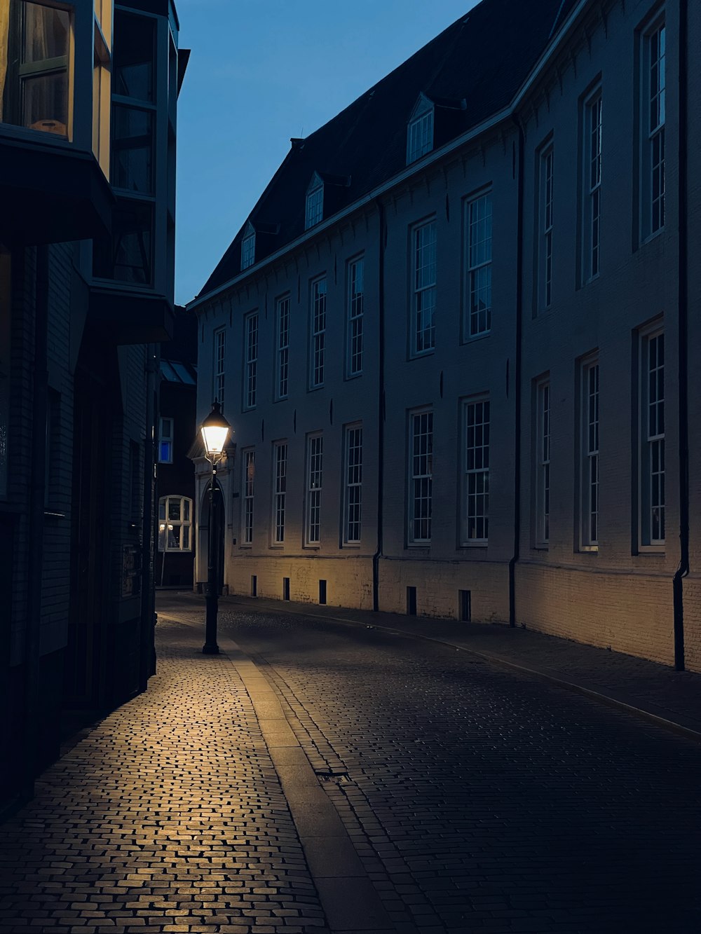 lighted street lamp on street during night time