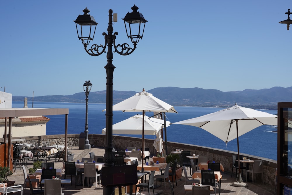 white patio umbrella near brown wooden table and chairs