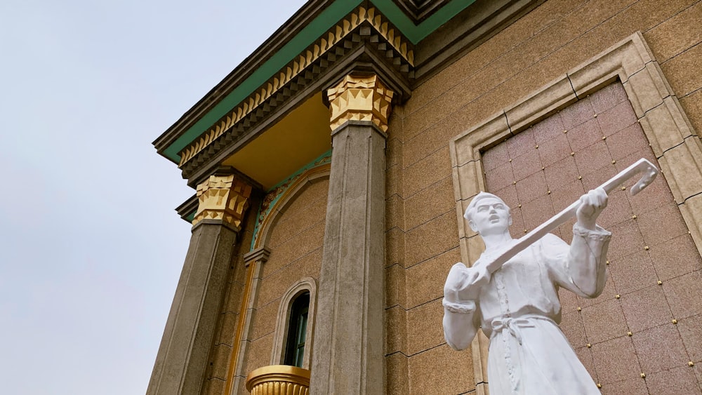 white concrete statue of man