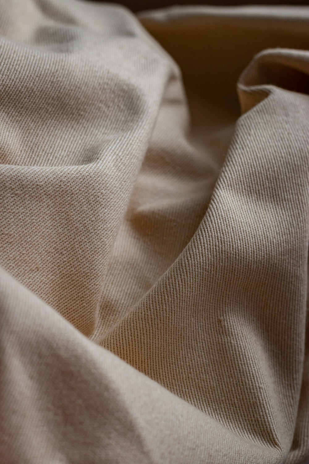 white textile on brown wooden table