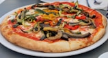 A freshly baked pizza topped with vibrant vegetables and cheese.