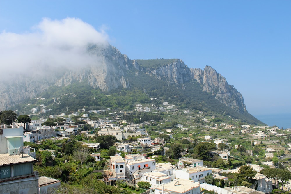 white and brown houses near mountain under blue sky during daytime