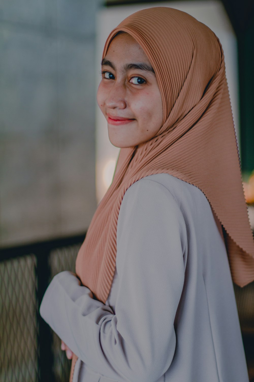 woman in brown hijab smiling
