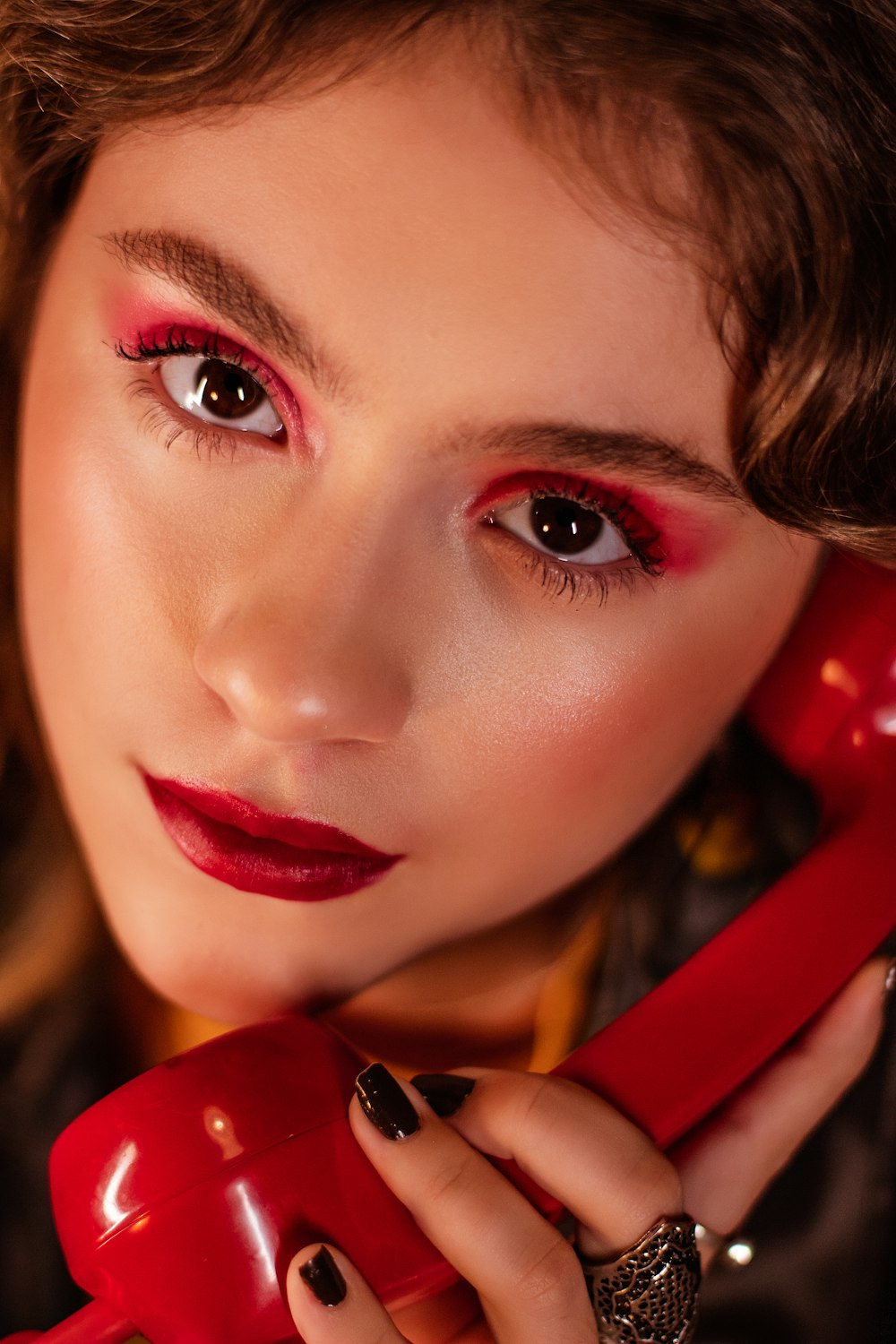 woman in red lipstick and yellow and black shirt