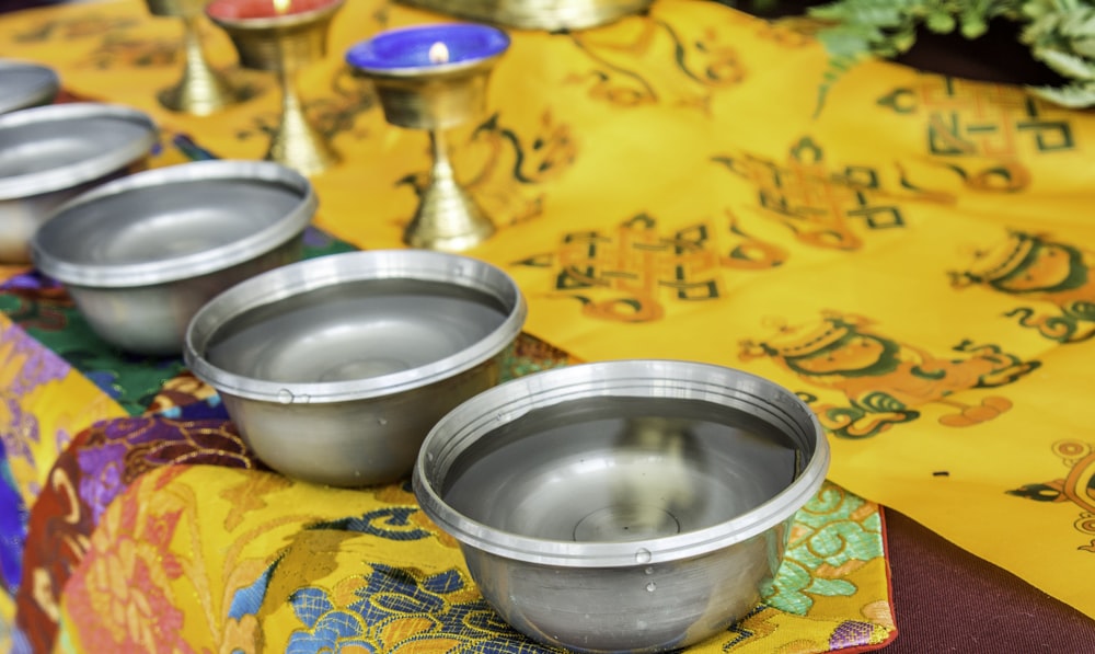 stainless steel bowl on yellow and blue textile