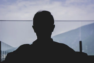 man in black shirt standing near body of water during daytime