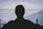 man in black shirt standing near body of water during daytime