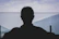 man in black shirt standing near body of water during daytime