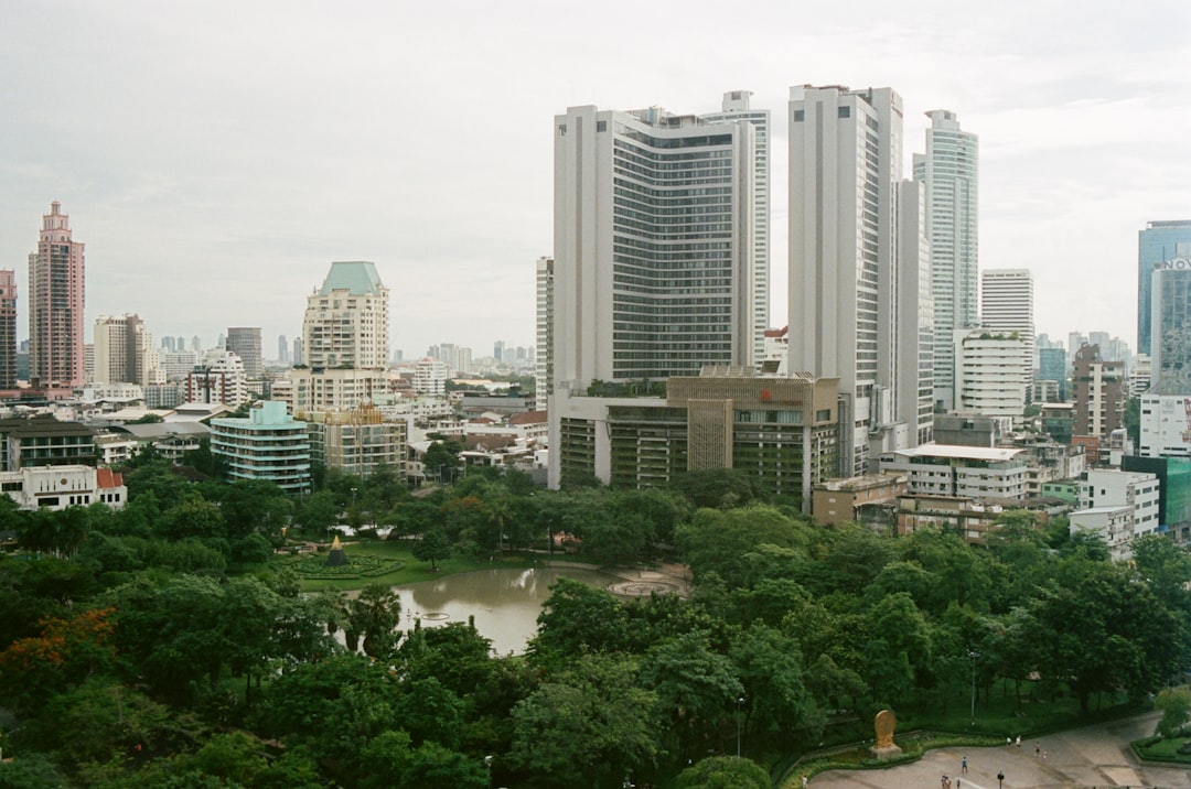 high rise buildings near green trees during daytime