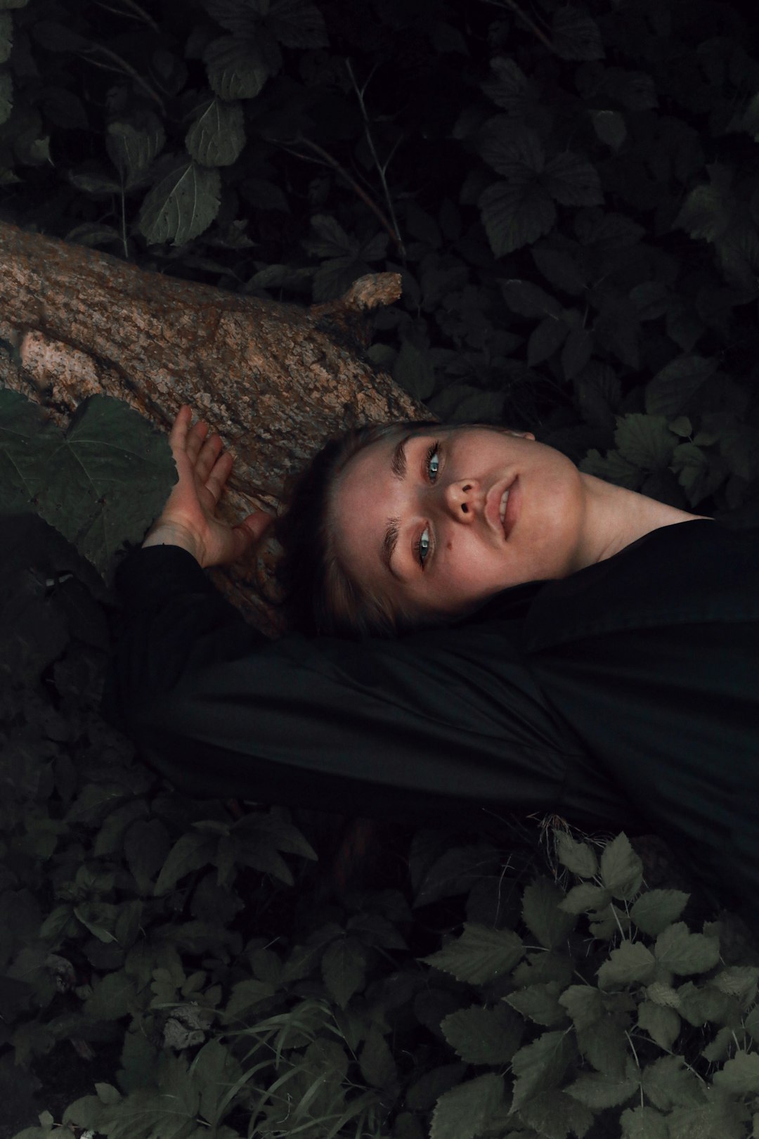 woman in black robe lying on ground