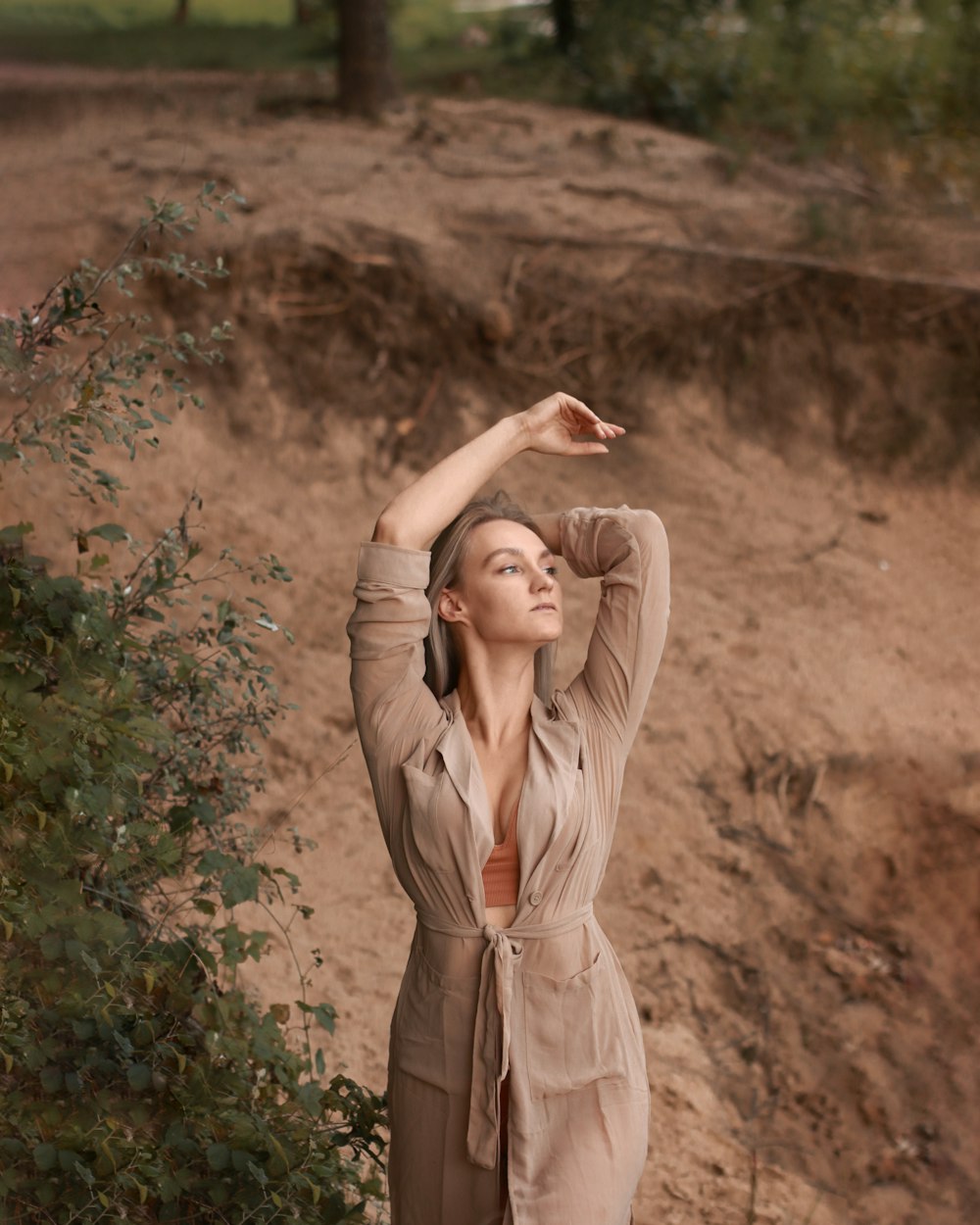 woman in brown long sleeve dress standing on brown field