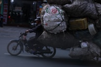 A sleek motorcycle being carefully loaded onto a tow truck in an urban Bogotá street.