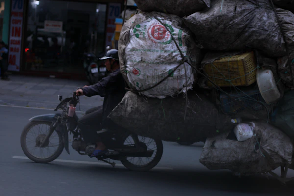 A sturdy work motorcycle loaded with delivery boxes in an urban setting.