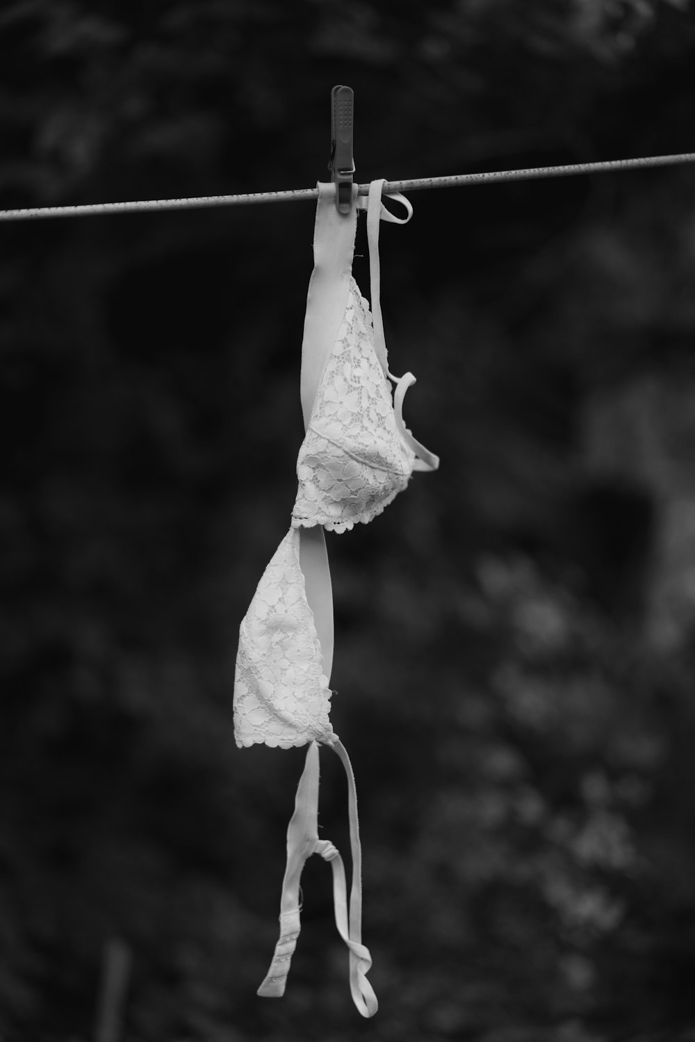 white textile on white clothes hanger