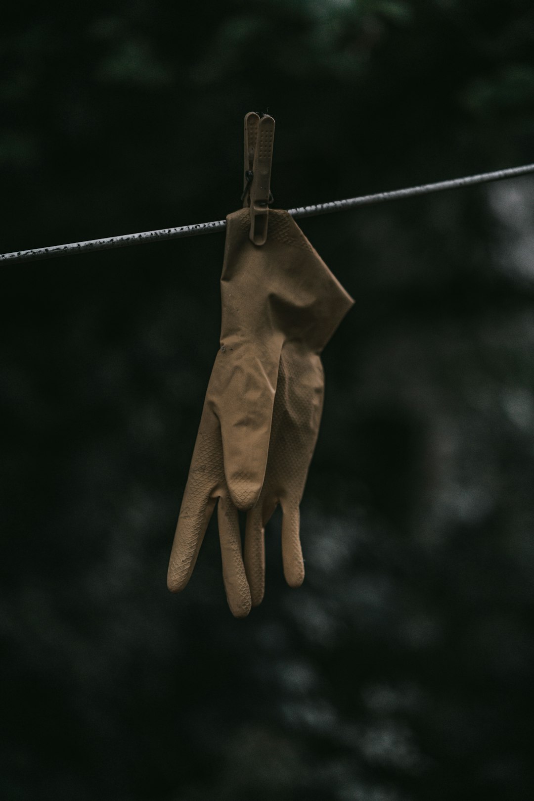 brown gloves hanging on brown rope